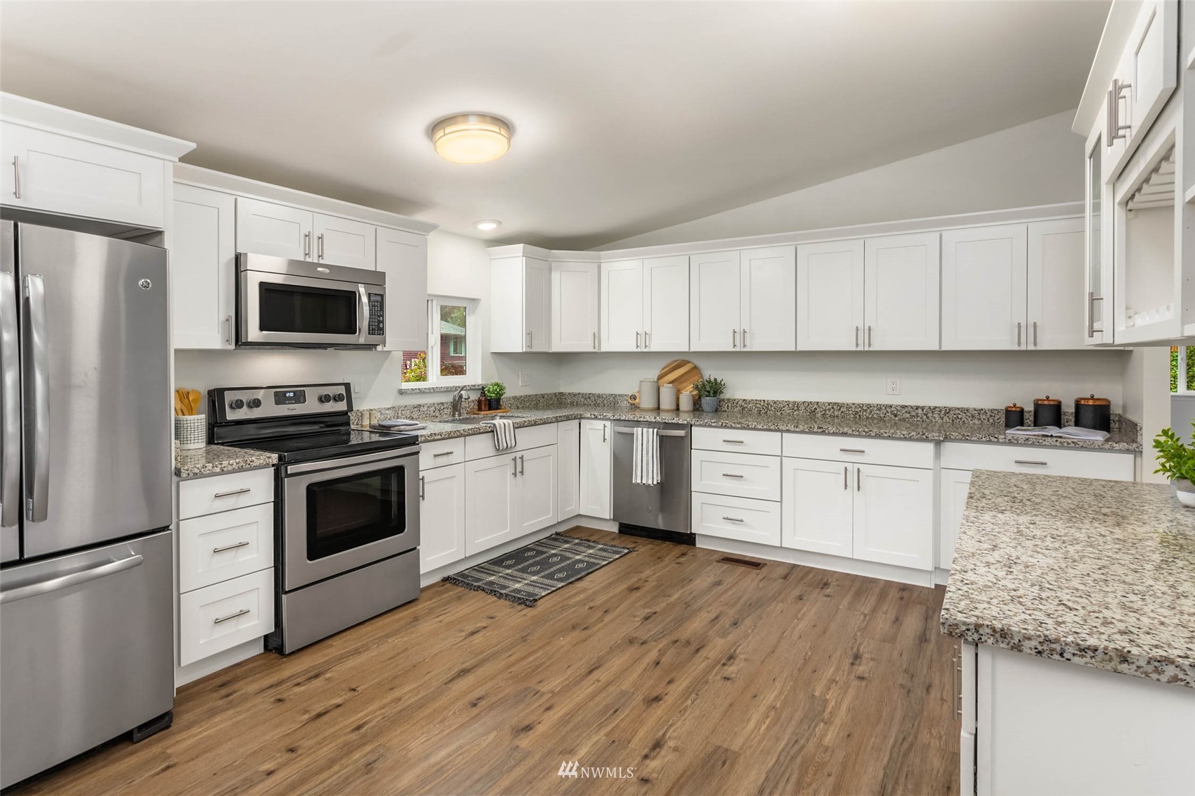 10701 Holly Drive Everett, WA 98204 - Photo 11 of 33 a kitchen with granite countertop white cabinets and stainless steel appliances
