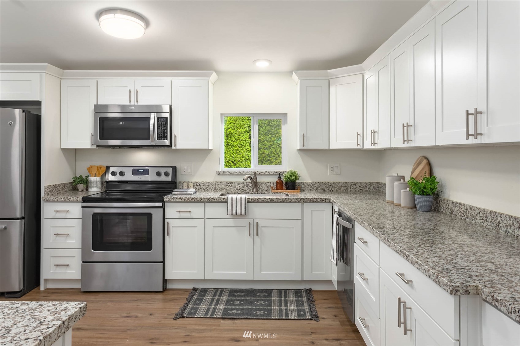 10701 Holly Drive Everett, WA 98204 - Photo 12 of 33 a kitchen with a sink stove and microwave