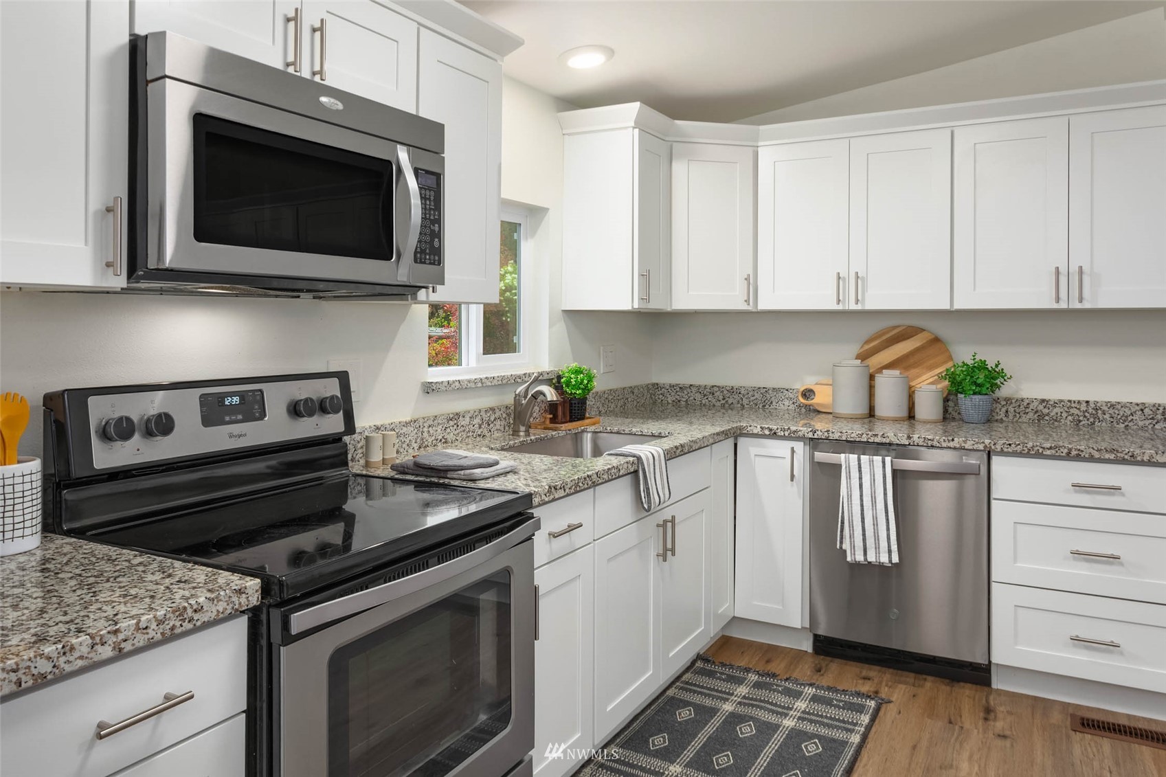 10701 Holly Drive Everett, WA 98204 - Photo 13 of 33 a kitchen with stainless steel appliances granite countertop a stove microwave and cabinets