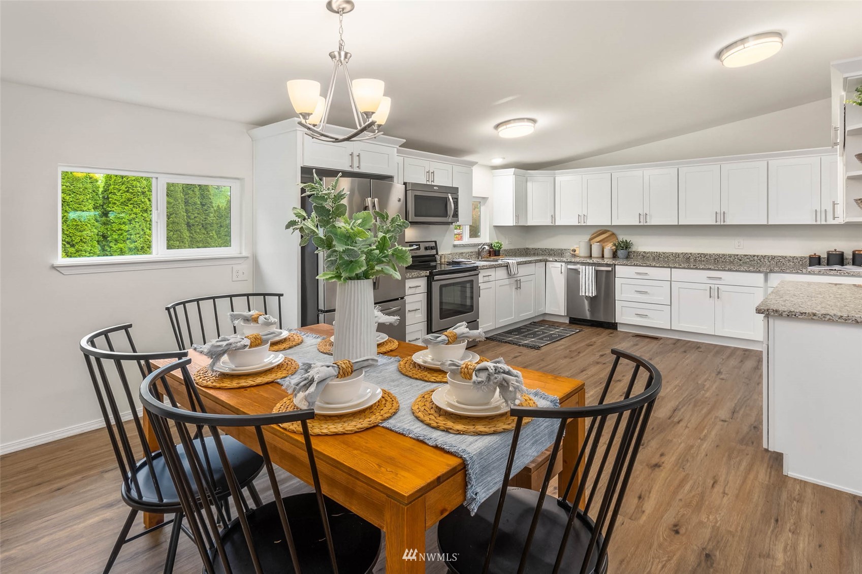 10701 Holly Drive Everett, WA 98204 - Photo 16 of 33 a dining room filled chandelier and wooden floor