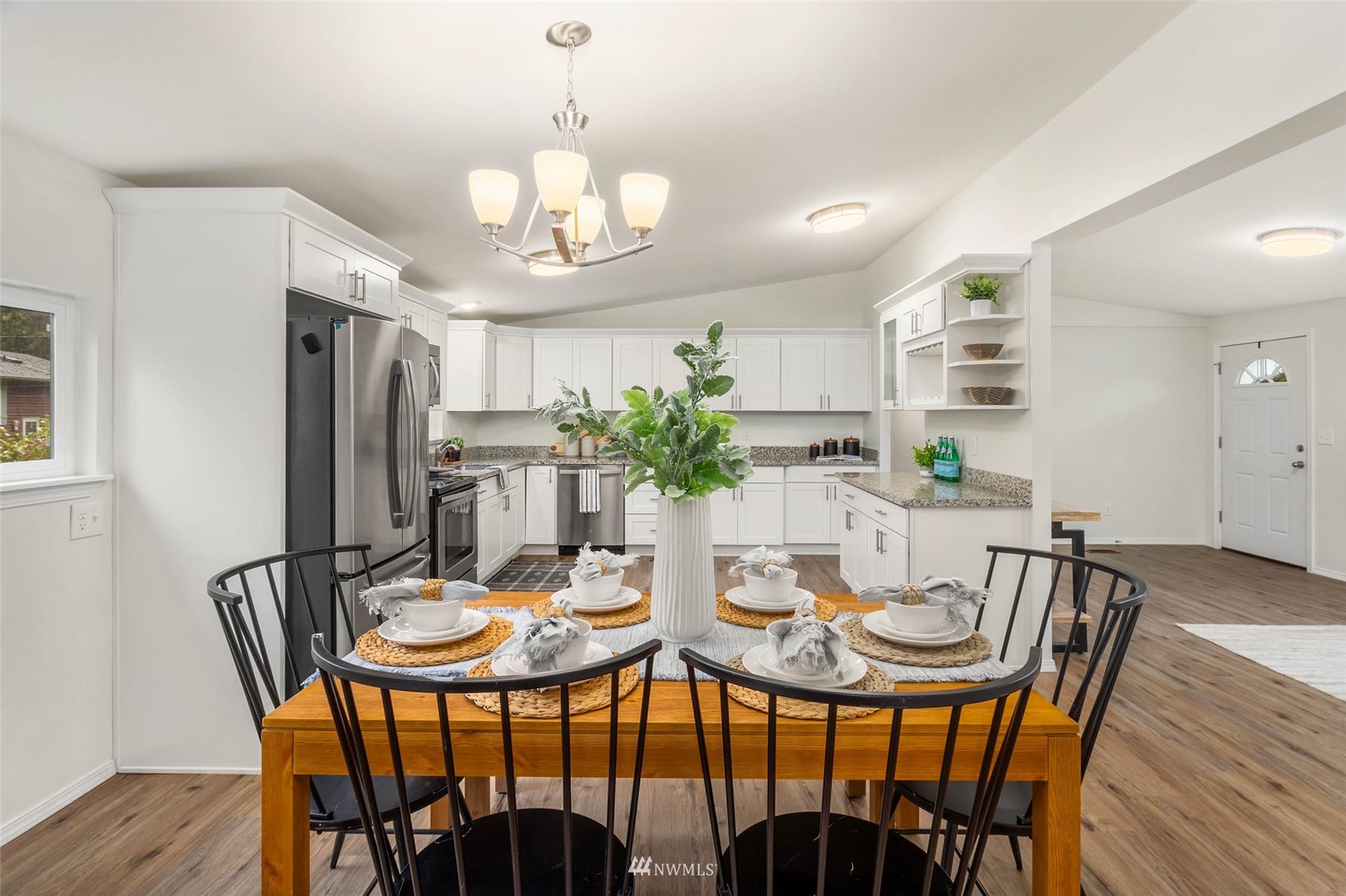 10701 Holly Drive Everett, WA 98204 - Photo 17 of 33 a view of a dining room with furniture window and wooden floor