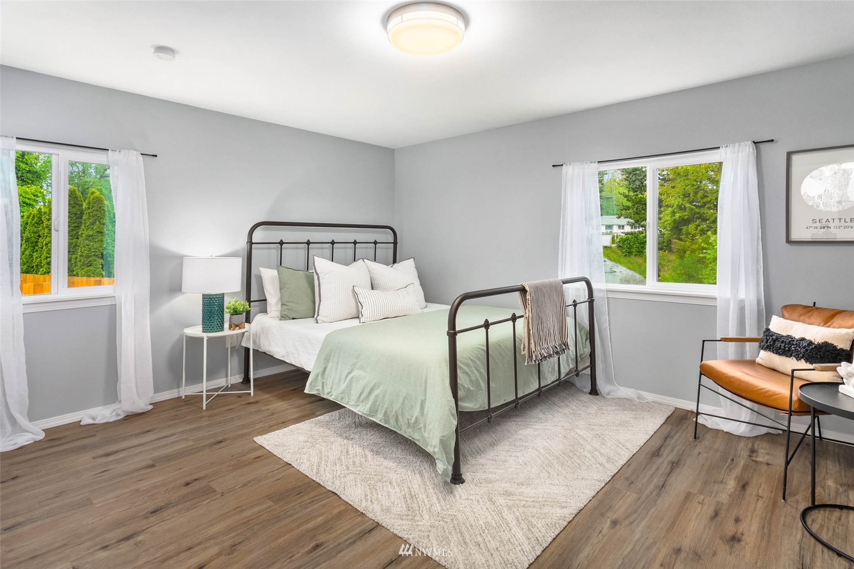 10701 Holly Drive Everett, WA 98204 - Photo 24 of 33 a bedroom with a bed and wooden floor