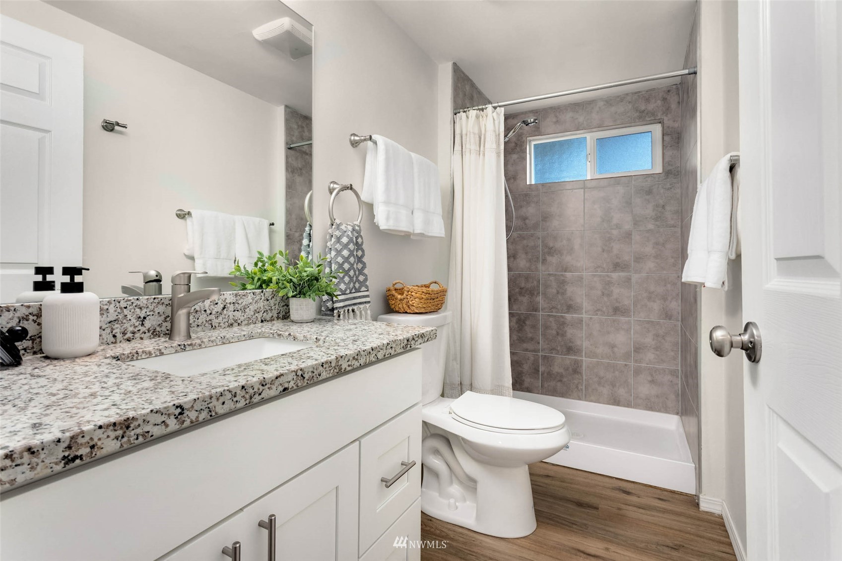 10701 Holly Drive Everett, WA 98204 - Photo 28 of 33 a bathroom with a granite countertop sink toilet and shower