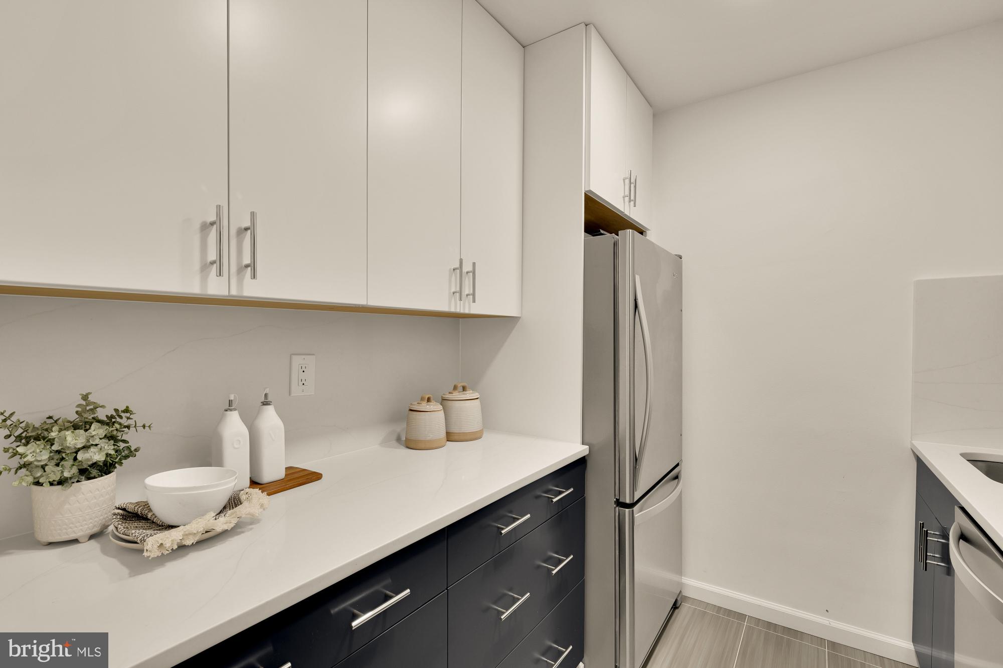 2400 41st Street Northwest, Unit 212 Washington, DC 20007 - Photo 11 of 24 a kitchen with a sink and cabinets