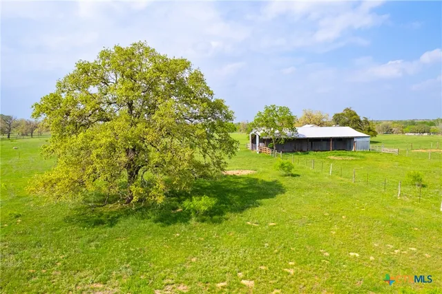 a backyard of a house with a yard and outdoor seating