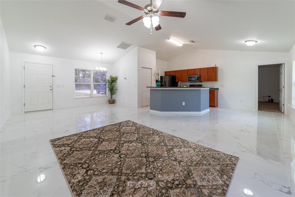 5107 Southwest 165th St Road Ocala, FL 34473 - Photo 6 of 34 a living room with furniture and a flat screen tv