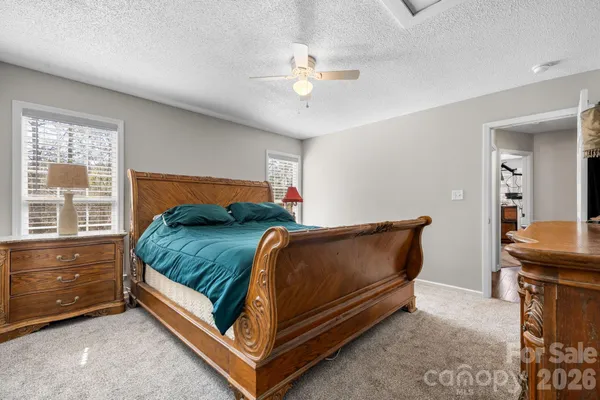 a bathroom with a granite countertop sink and a toilet