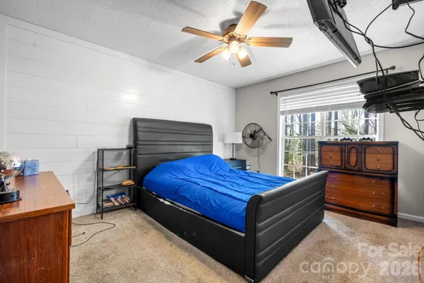 a bathroom with a granite countertop sink toilet mirror and shower