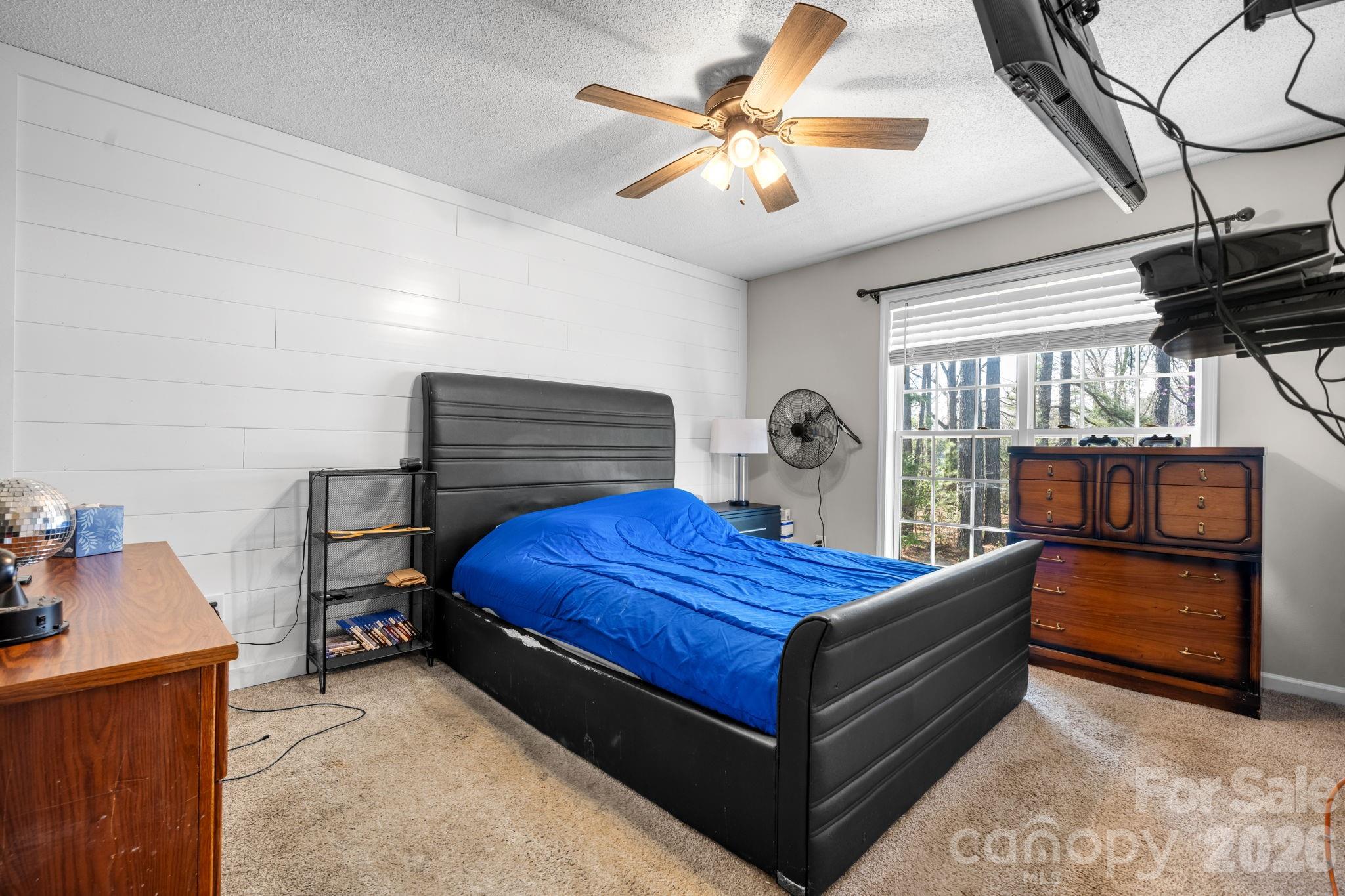 120 Wesley Court Crouse, NC 28033 - Photo 27 of 36 a bedroom with a bed and a chandelier
