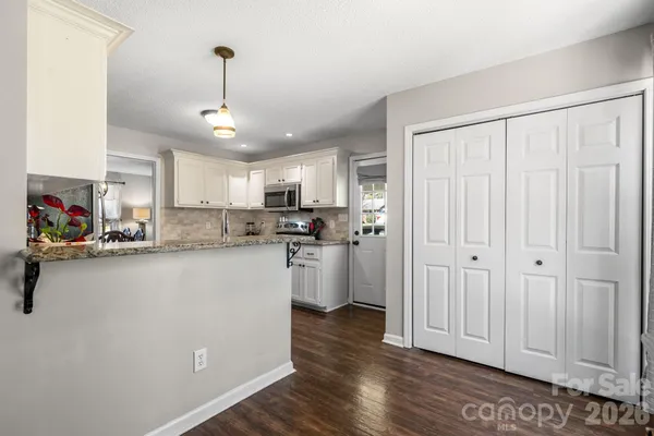 a kitchen with stainless steel appliances granite countertop a refrigerator sink and cabinets