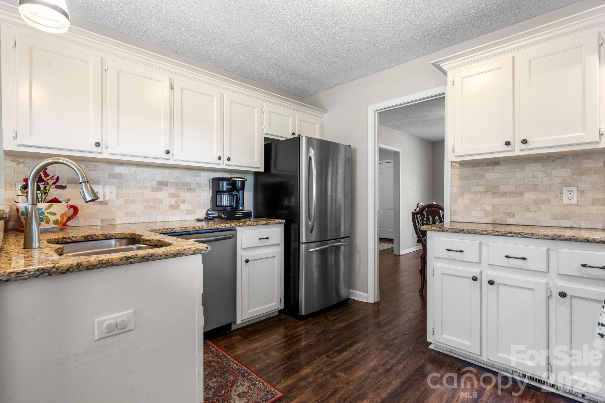 120 Wesley Court Crouse, NC 28033 - Photo 35 of 36 a kitchen with stainless steel appliances granite countertop a refrigerator sink and cabinets