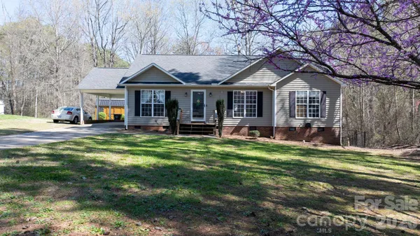 a front view of a house with a yard table and chairs