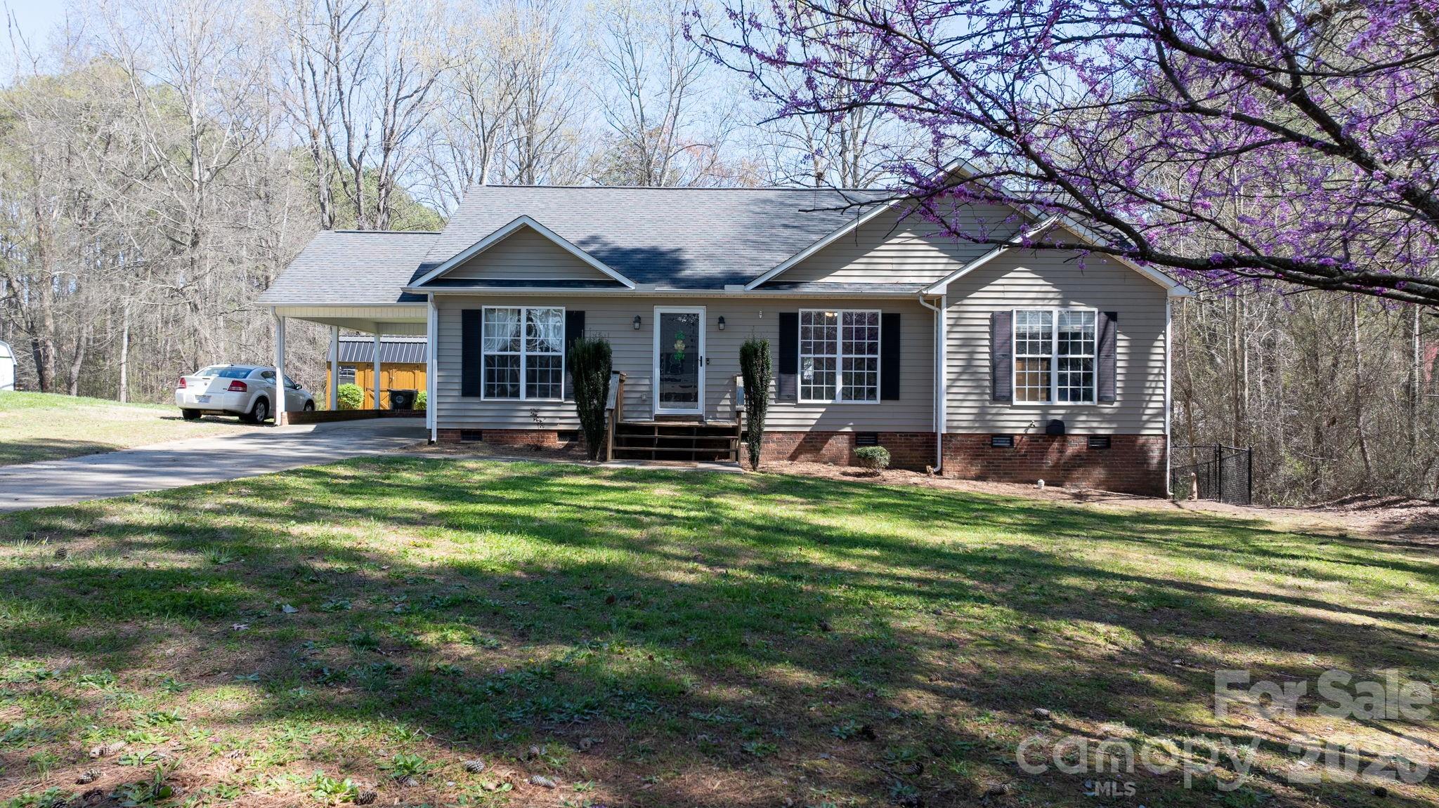 120 Wesley Court Crouse, NC 28033 - Photo 4 of 36 a front view of a house with a yard table and chairs