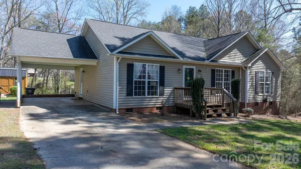 a view of a house with backyard porch and sitting area