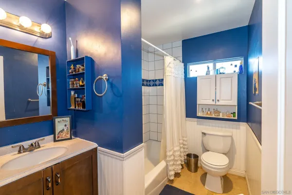 a view of a patio with a table and chairs under an umbrella