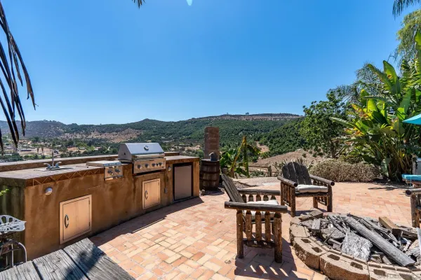 a view of a house with backyard and sitting area