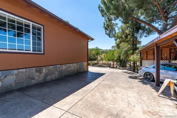 a bedroom with a bed a dresser and a flat screen tv
