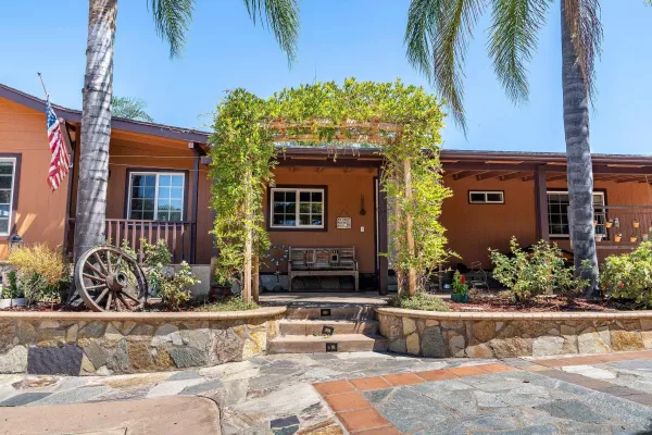 a kitchen with stainless steel appliances kitchen island granite countertop a stove refrigerator and cabinets