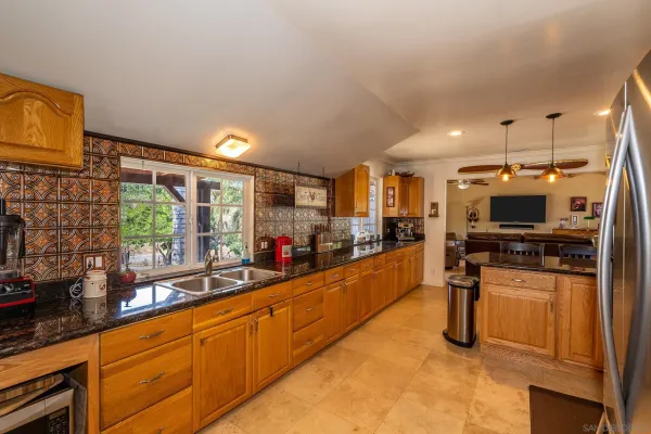 a room with pool table flat screen tv table and windows