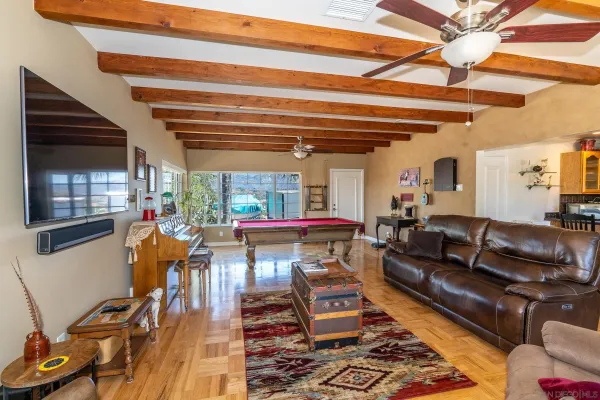 a bedroom with a large bed and a chandelier