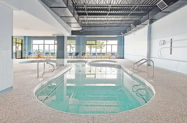 a view of a living room and kitchen with a large window