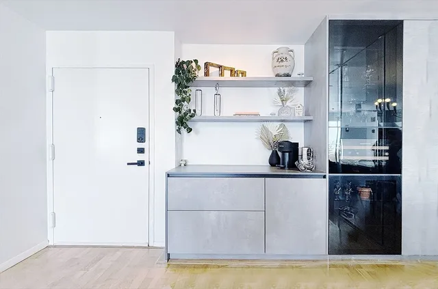 a kitchen with cabinets and a refrigerator