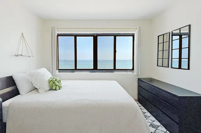 a bedroom with a bed and window