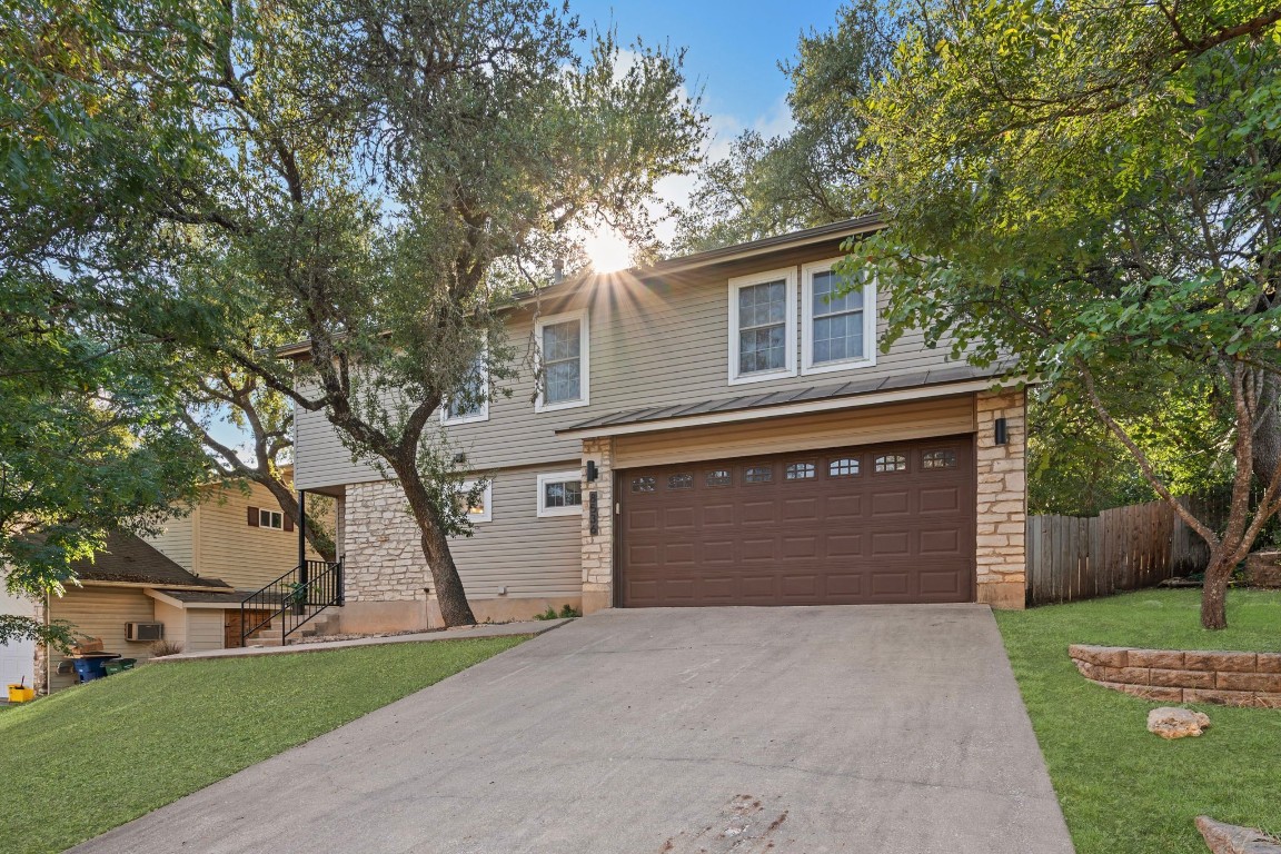 a front view of a house with a yard and garage