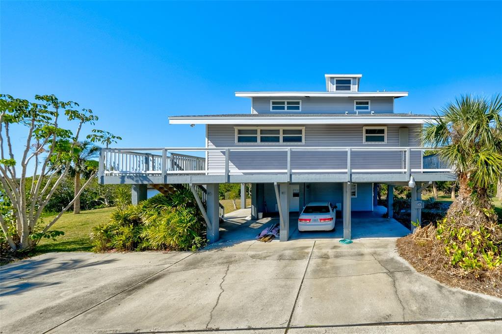 145 Burns Road Terra Ceia, FL 34250 - Photo 22 of 65 a view of a house with a patio and a yard