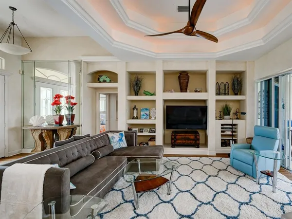 a living room with furniture a flat screen tv and a fireplace