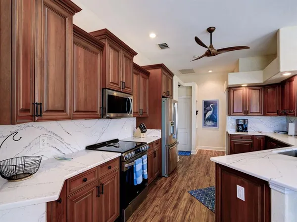 a kitchen with stainless steel appliances granite countertop a sink stove and refrigerator