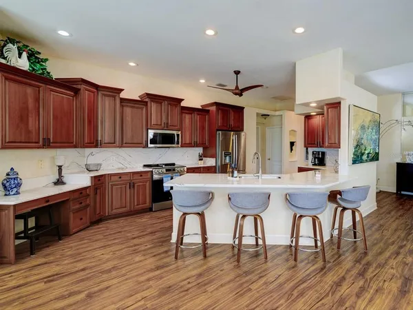 a kitchen with a sink cabinets and wooden floor