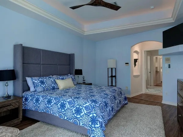 a bedroom with a large bed and a television