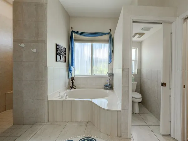 a bathroom with a granite countertop sink a toilet and shower