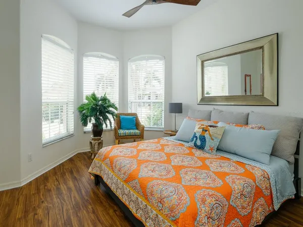 a bedroom with bed and windows