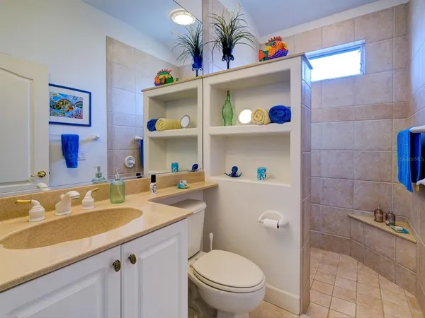 a bathroom with a sink a toilet and a shower