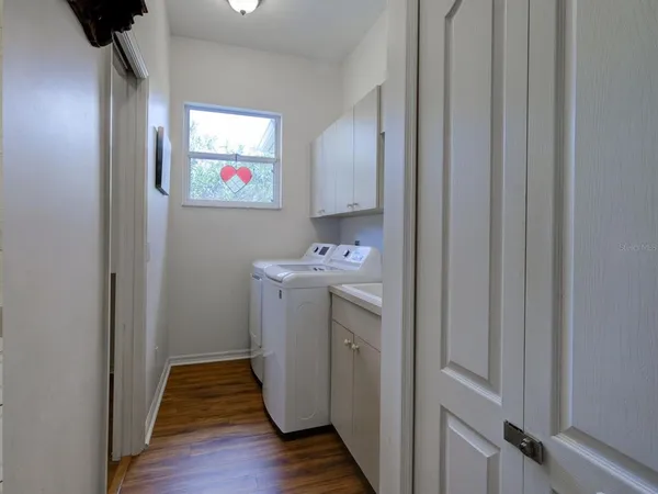 a view of a hallway with washer and dryer