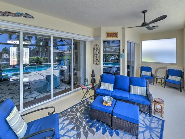 a living room with furniture and a glass door