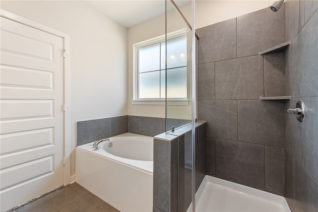 2415 Rooke Road Bryan, TX 77807 - Photo 30 of 36 a bathroom with a bathtub and window