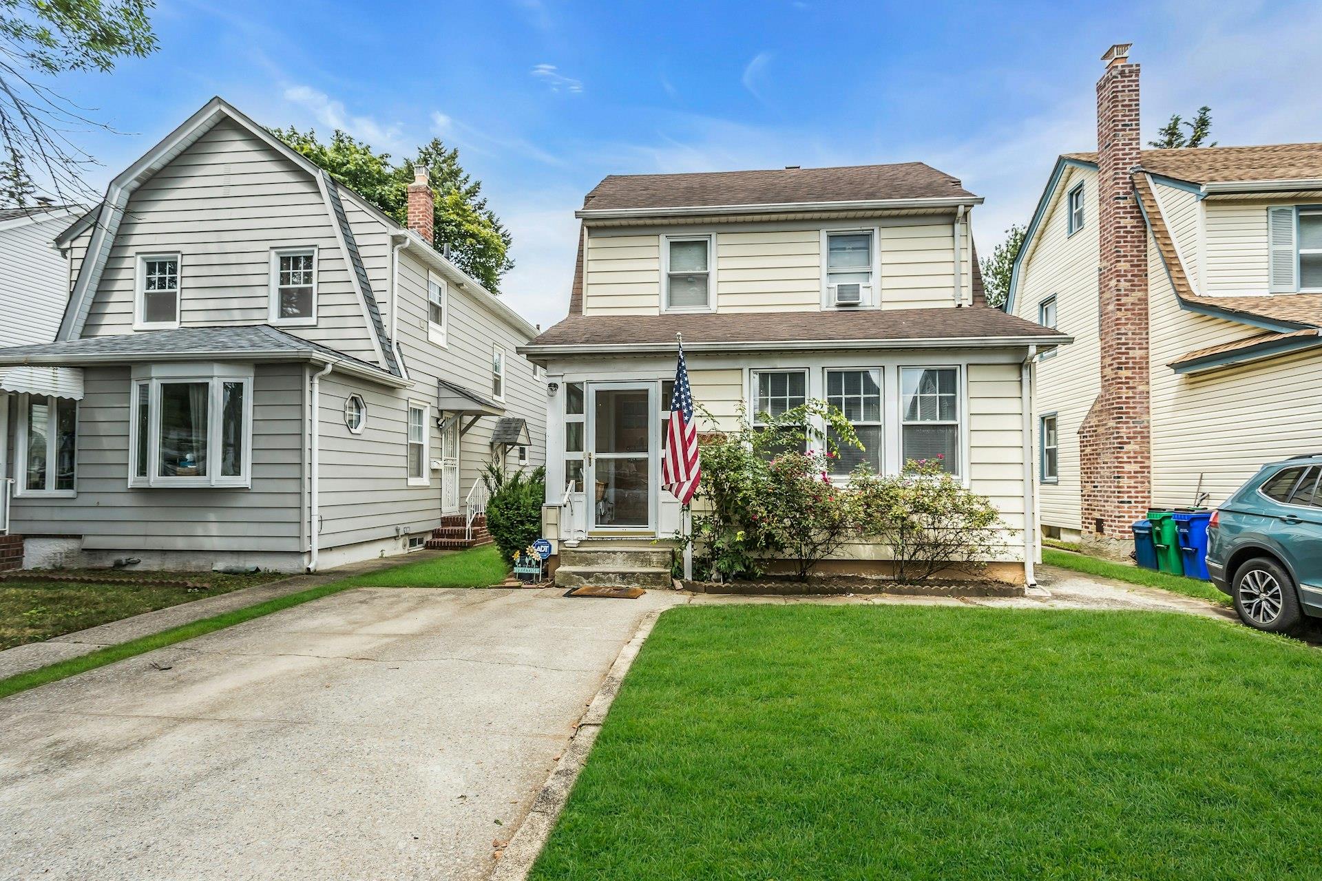 View of front of home featuring entry steps, a front yard, and roof with shingles