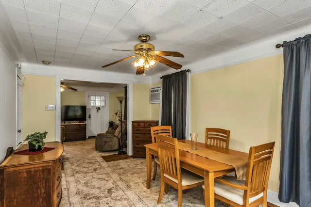 a dining room with furniture and chandelier