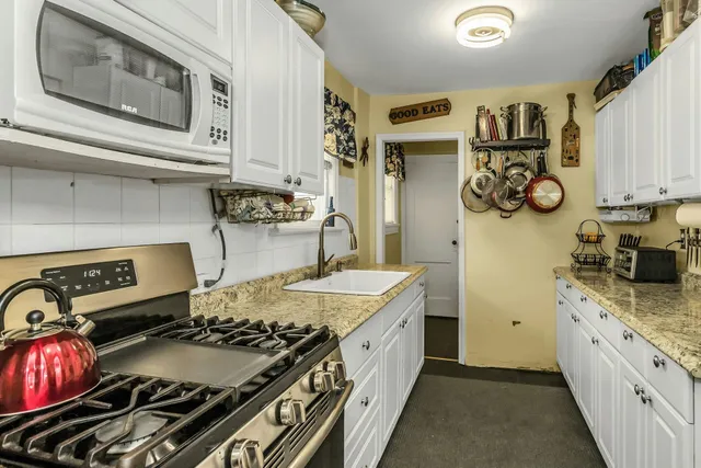 a kitchen with a stove and a sink