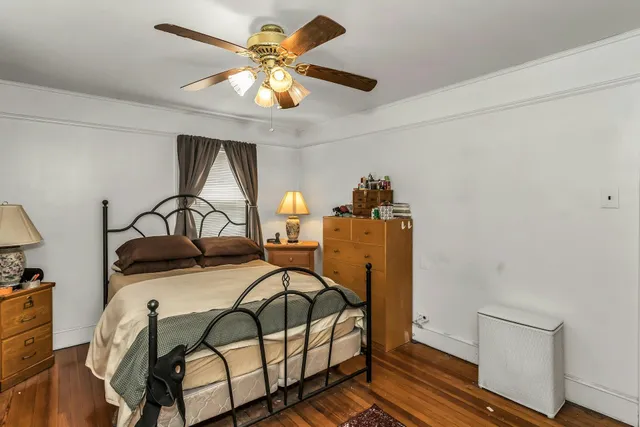 a bedroom with furniture and a chandelier