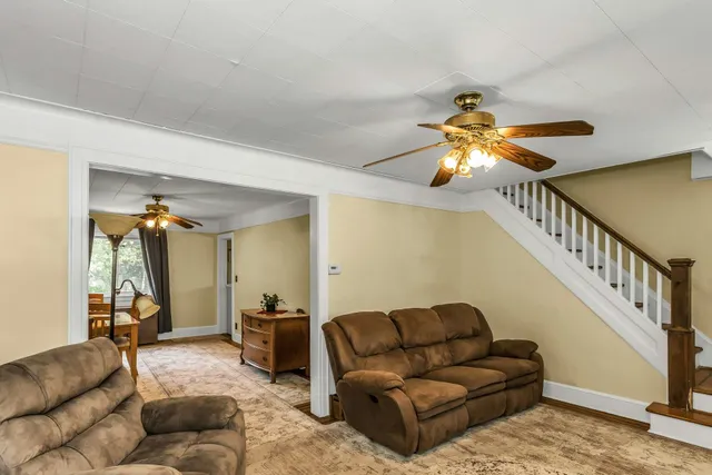 a living room with furniture and a chandelier