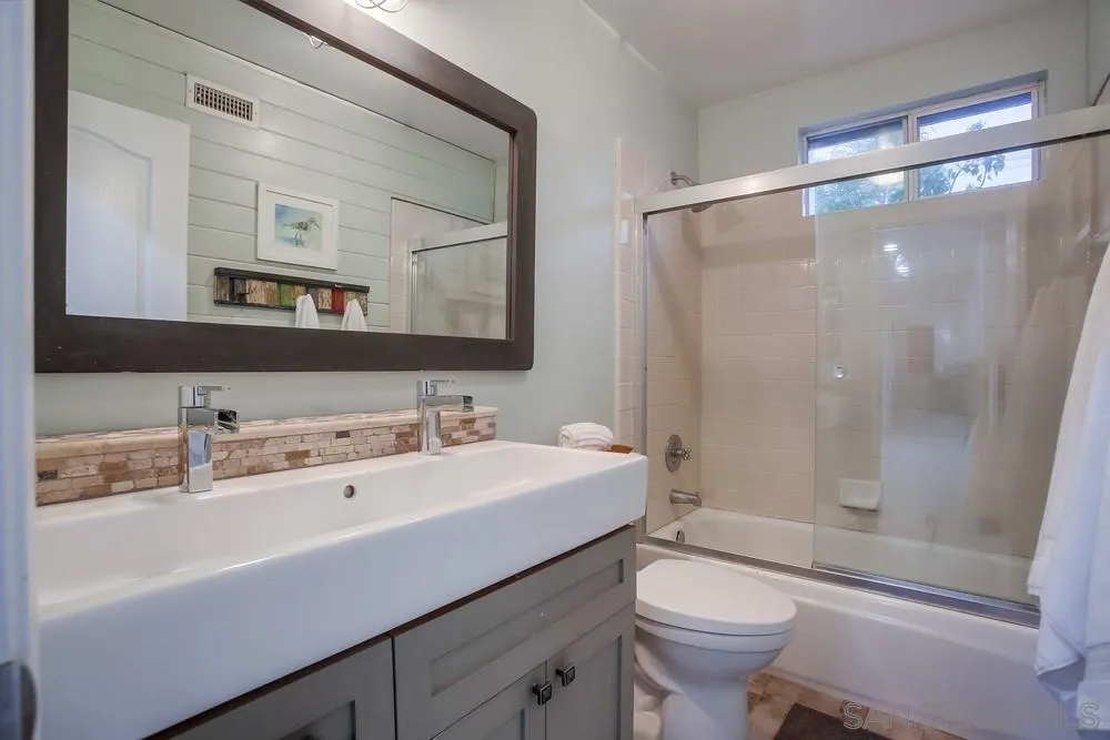 2150 Corte Cidro Carlsbad, CA 92009 - Photo 32 of 49 a bathroom with a sink toilet mirror and shower