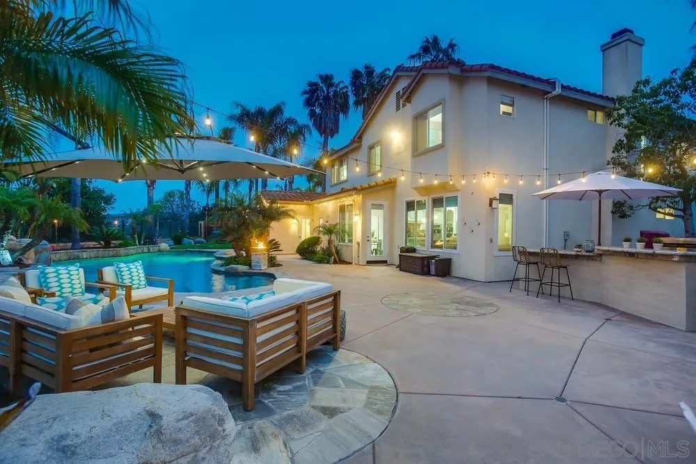 2150 Corte Cidro Carlsbad, CA 92009 - Photo 40 of 49 a view of a patio with a table and chairs under an umbrella
