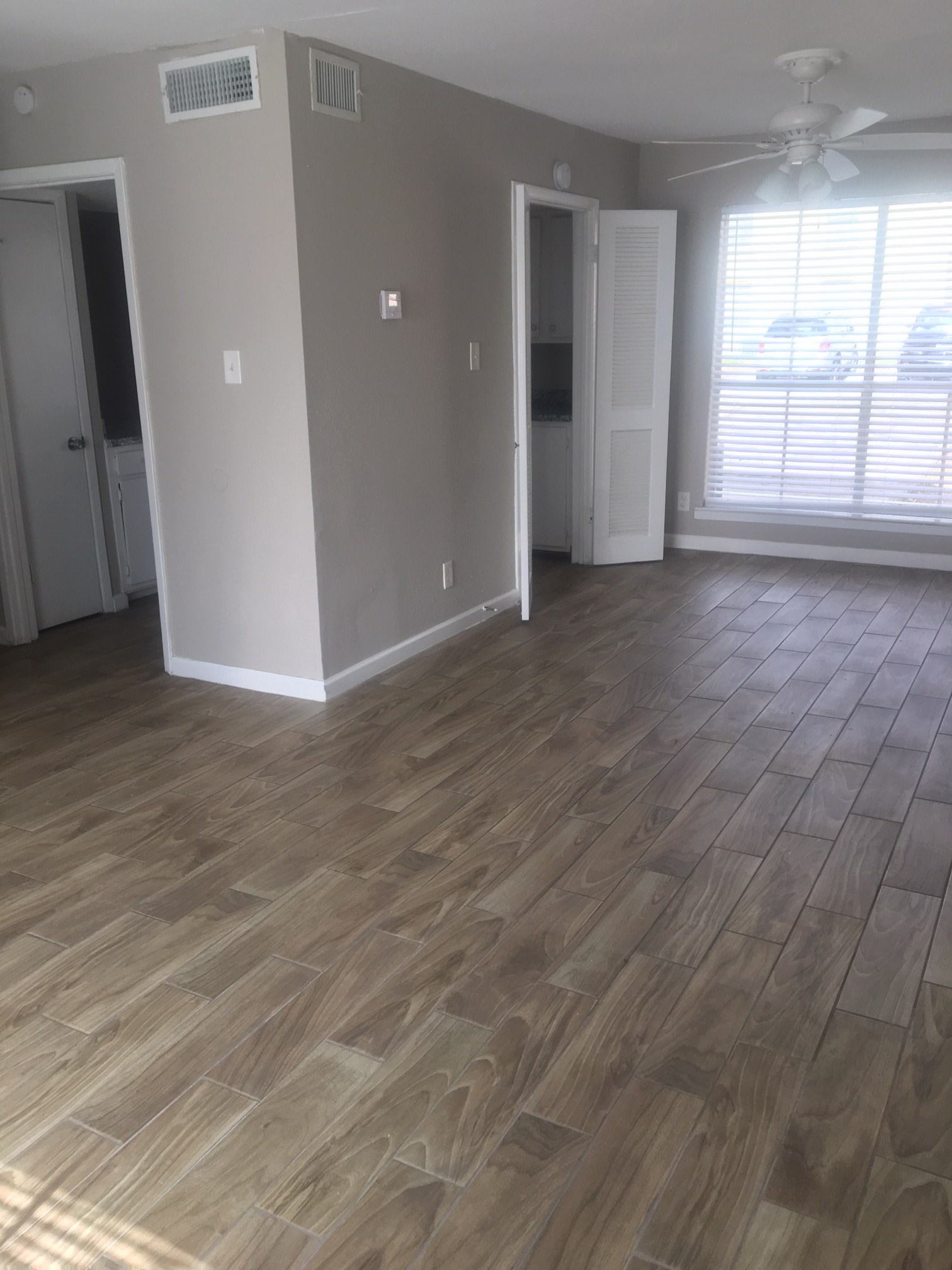 6200 West Tidwell Road, Unit 901 Houston, TX 77092 - Photo 3 of 12 an empty room with wooden floor and windows