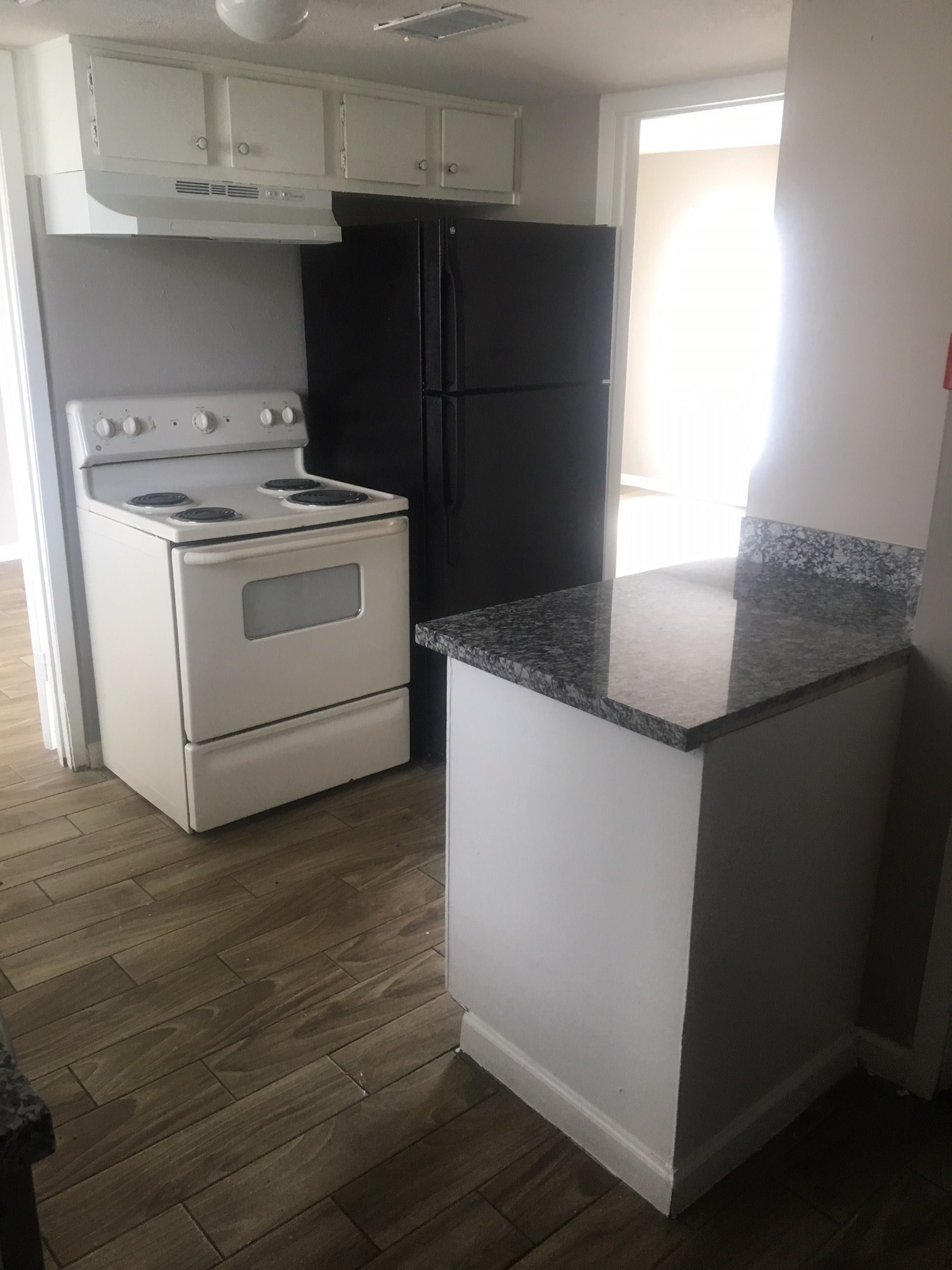 6200 West Tidwell Road, Unit 901 Houston, TX 77092 - Photo 5 of 12 a kitchen with granite countertop cabinets appliances and a window
