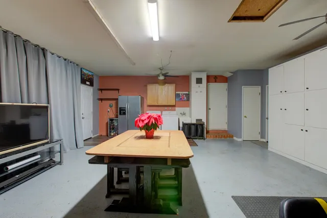 a kitchen with stainless steel appliances wooden floor dining table and chairs