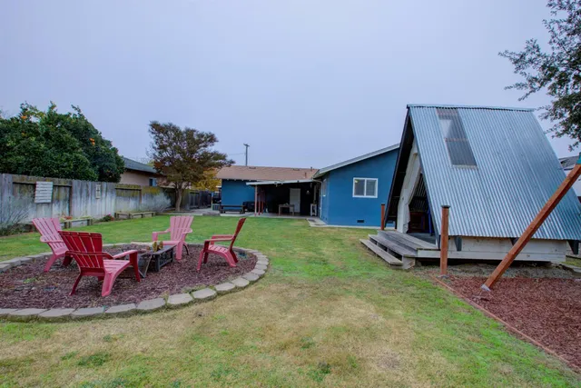 a view of a house with backyard porch and sitting area